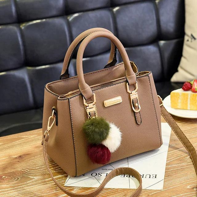 Structured Pebbled Leather Top-Handle Tote Bag with Pom-Pom Charm & Crossbody Strap