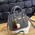 Structured Pebbled Leather Top-Handle Tote Bag with Pom-Pom Charm & Crossbody Strap