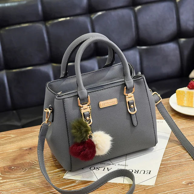 Structured Pebbled Leather Top-Handle Tote Bag with Pom-Pom Charm & Crossbody Strap