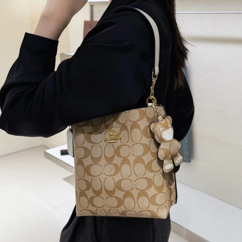 CLENLE Women's Vintage Monogram Bucket Bag – Signature Canvas Shoulder Tote & Crossbody Handbag with Bear Charm